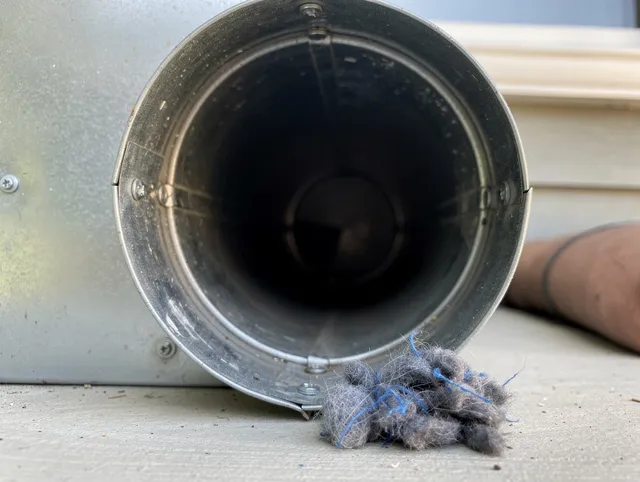 Warrensville Heights Dryer Vent Cleaning technician using specialized equipment to clear severe dryer vent blockage in Warrensville Heights